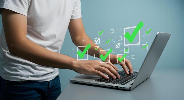 Man using laptop computer checking tasks completing online todo list digital checklist concept successful project completion photo