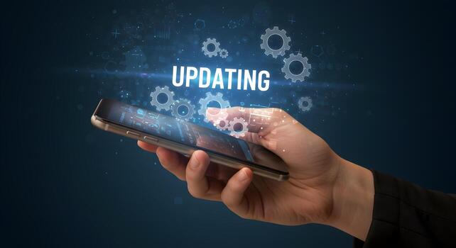 Hand using smartphone to update software digital gears and updating text on screen technology concept image photo