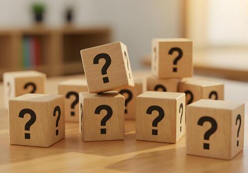 Wooden Cubes with Question Marks on a Desk Representing Uncertainty and the Search for Answers in a Modern Home Office Setting photo