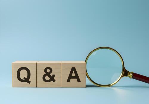 Wooden Blocks Spelling QA with Magnifying Glass on Blue Background - Concept of Search Questions Answers and Solutions photo