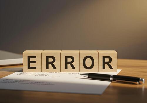 Wooden Blocks Spelling Error on Desk with Pen and Paper Showing Problem Mistake and Failure Concept photo