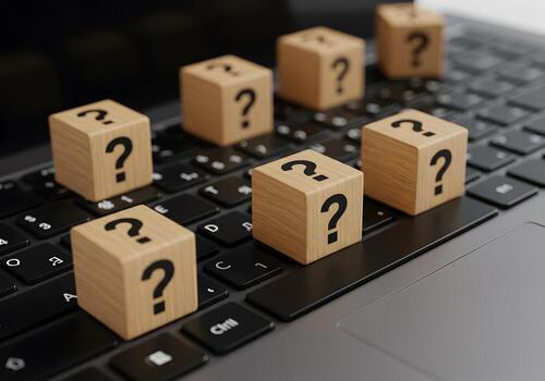 Wooden Blocks with Question Marks on Laptop Keyboard Uncertainty and Online Problem Solving Concept photo