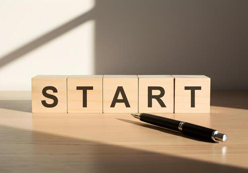 Wooden Blocks Spelling START on Desk with Pen Symbolizing New Beginnings and Motivation in a Bright Office Setting photo
