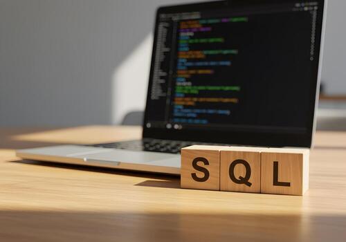 SQL Database Code on Laptop Screen with Wooden Blocks on Desk Software Development Concept photo