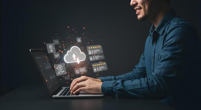 Smiling man using laptop computer managing cloud data and online reviews working late at night in a dark modern office showcasing efficient workflow and digital success photo