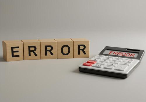 Wooden blocks and calculator displaying the word ERROR on a light gray surface representing a concept of mistake fault problem or failure in calculation or system photo