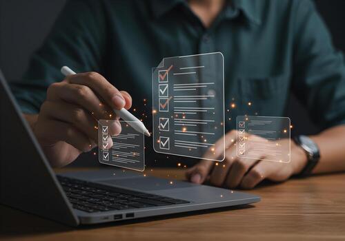 Person using stylus pen checking items on a digital checklist projected from laptop screen at modern workplace concept of planning task management and productivity photo