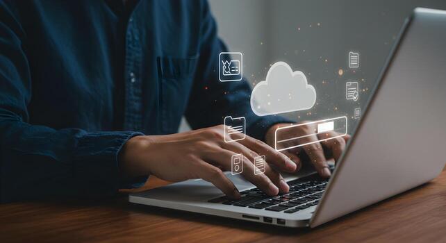 Person working on laptop computer accessing cloud data and digital files in a modern home office setting showcasing the concept of remote work and digital storage photo