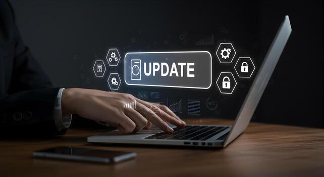 Person in business suit initiates software update on laptop working late at night in modern office illuminated by screen glow signifying progress and technological advancement photo