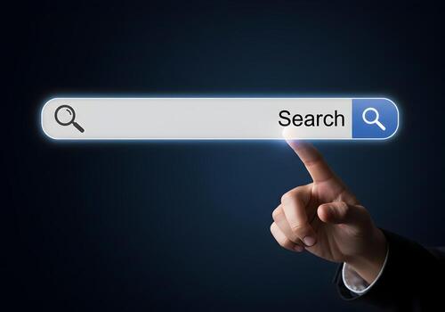 Closeup of a finger about to click on a search bar with a magnifying glass icon on a darkblue background The concept is internet search exploration and discovery photo