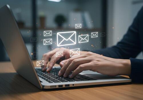 Persons hands typing an email on a laptop computer in a modern office email marketing concept image The image depicts a person actively engaging in digital communication showcasing the process of send photo
