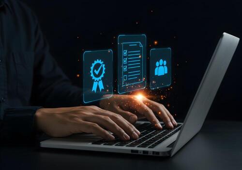 Person working on laptop computer at night achieving quality results and team collaboration symbolized by glowing digital icons of checklist teamwork and quality award photo