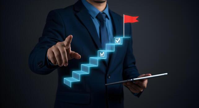 Businessman using digital tablet pointing at a glowing staircase leading to success symbolized by a red flag representing growth achievement and progress in business and career photo