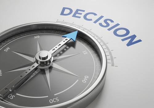 Compass needle pointing to the word DECISION on white background symbolizing choices direction and strategic planning for business and life The image evokes concepts of navigation guidance and making photo