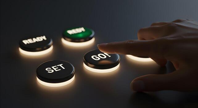 Hand about to press a glowing GO button among Ready and Set buttons on a dark surface symbolizing the start of a project a race or a new beginning photo
