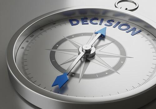 Compass pointing towards the word DECISION symbolizing making choices strategic planning and finding direction in life or business The metallic compass needle guides towards a critical decision repres photo