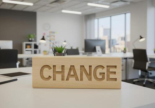Wooden block with the word CHANGE on a modern office desk signifying transformation and new beginnings in a contemporary workspace photo