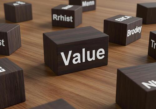 Wooden blocks spelling out the word Value on a table signifying importance worth and high value in business and finance concepts photo