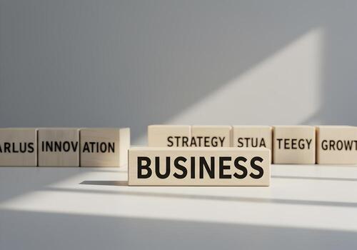 Wooden blocks spelling out the word BUSINESS showcasing concepts of innovation strategy and growth in a modern office setting symbolizing business success and development photo