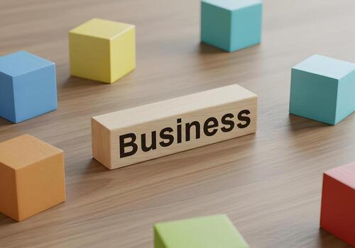 Wooden block with the word Business surrounded by colorful cubes on a desk symbolizing growth and strategy in a modern business environment photo