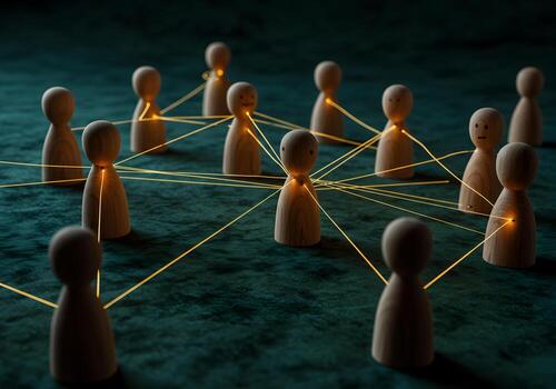 Wooden figures interconnected by glowing threads on a darkgreen surface symbolizing a network connection and communication concept photo