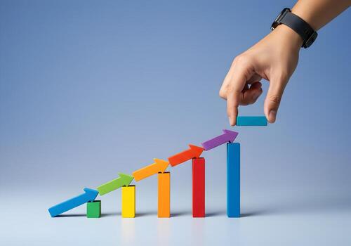 Hand arranging colorful arrow blocks to represent growth and upward trend symbolizing progress and success in business or finance The image conveys concepts of development achievement and strategic pl photo