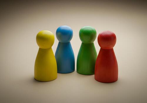 Colorful wooden game pieces stand together on a neutral background symbolizing unity diversity and teamwork in a collaborative setting photo