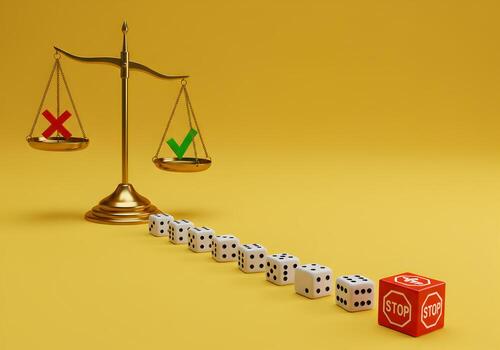 Golden scales of justice weighing risk and reward with a line of dice leading to a stop sign on a yellow background symbolizing decisionmaking and risk assessment in business and life choices photo