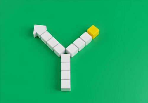 White and yellow blocks forming diverging paths on green background symbolizing choices and decisionmaking process photo