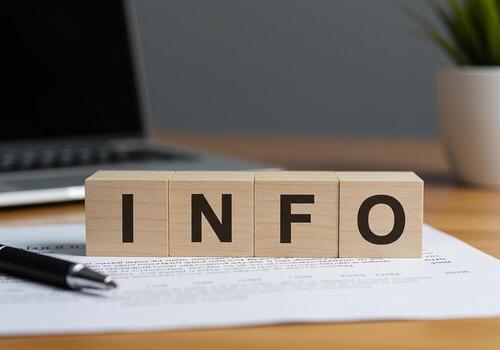 Wooden Blocks Spelling INFO on a Desk with Documents and Laptop in the Background Representing Business Data and Communication photo