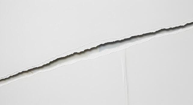 White Paper Ripped Apart Revealing a Gap Creating a Dramatic and Textural Background Image Ideal for Design Projects Presentations or Layouts The image features a stark contrast and a sense of discont photo