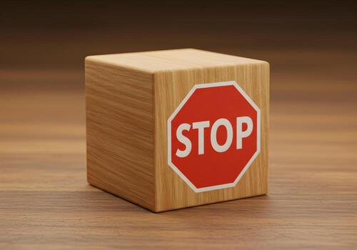 Red stop sign on a wooden cube on a wooden surface a concept of pause halt or prevention The image is ideal for illustrating concepts related to decisionmaking risk management or taking a break photo