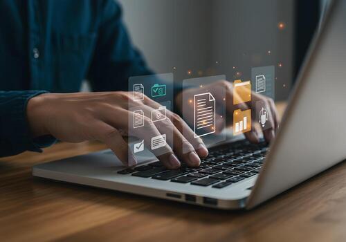 Person working on laptop computer managing digital documents and data in a modern office showcasing efficiency and digital workflow photo