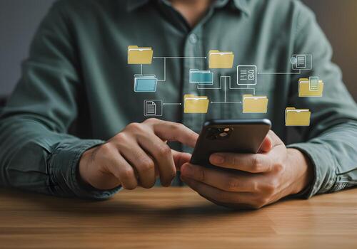 Person using smartphone to access and manage digital files and folders in a cloud storage system showcasing efficient remote data organization and accessibility photo
