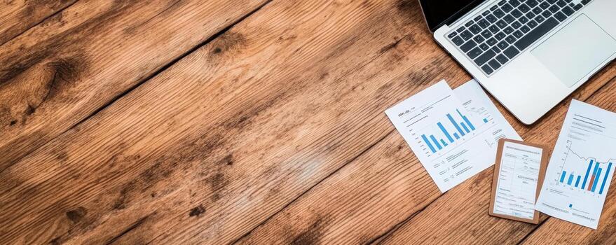 Workplace setup with computer charts and clipboard on rustic wood photo