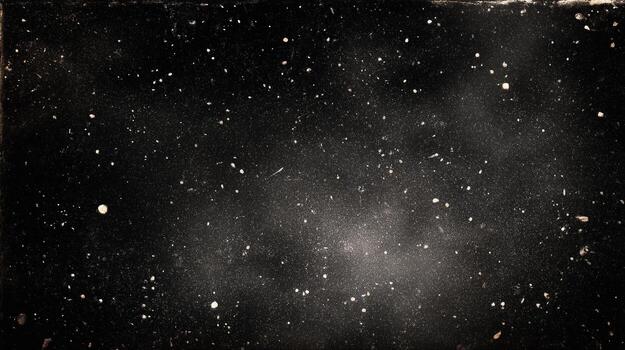 A dark background with white specks scattered across the surface creating a textured appearance photo