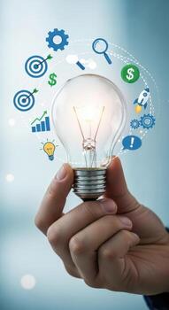 A hand holding a lightbulb surrounded by icons representing business and innovation concepts idea bulb photo