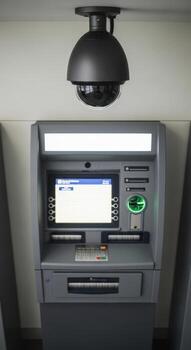 A security camera above an automated teller machine in a public indoor space location photo