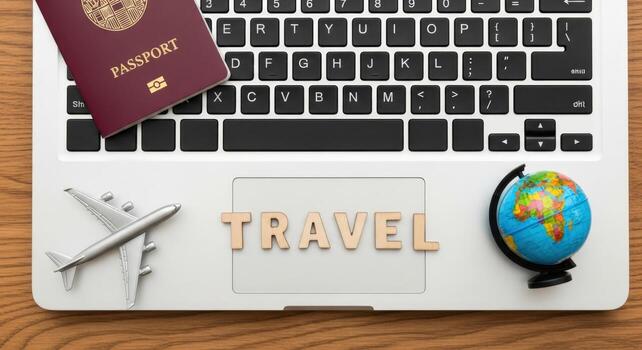 A laptop with passport airplane globe and wooden letters spelling travel on a wooden surface view from above photo