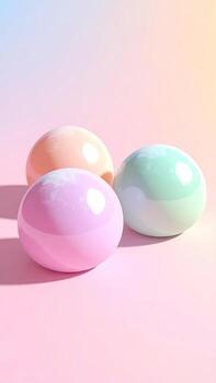 Three pastel-colored spheres rest on a soft pink surface, their smooth textures and gradient hues creating a playful and calming aesthetic. photo