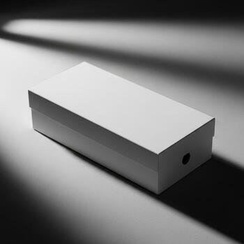 A closed rectangular white cardboard box casting a shadow on a light gray surface isolated on white background photo