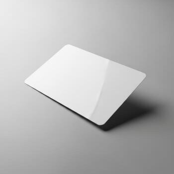 Blank white plastic card mockup with subtle shadow and reflection isolated on white background photo