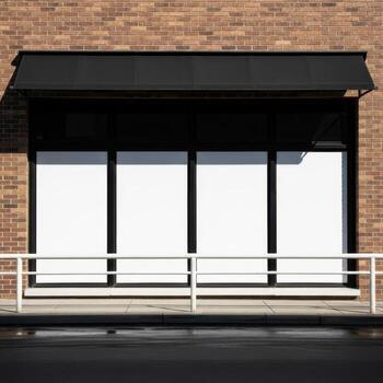Empty storefront with large windows and a black awning isolated on white background photo