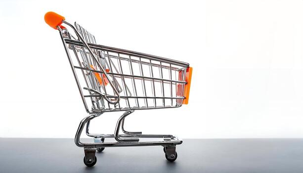 Miniature Shopping Cart on Gray Surface, E-commerce, Retail Concept photo