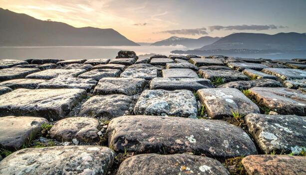 Cobblestone setts with lime mortar flush desaturated palette wallpaper background representing paving texture detail suitable for urban heritage design photo