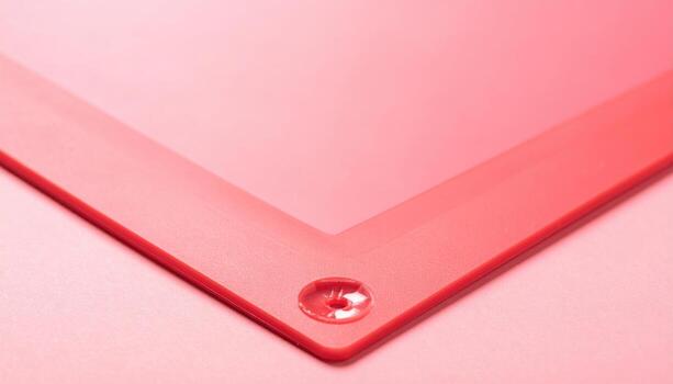 Plain silicone baking mat surface pastel red muted copy band wallpaper background representing kitchen tool texture suitable for clean food styling design photo