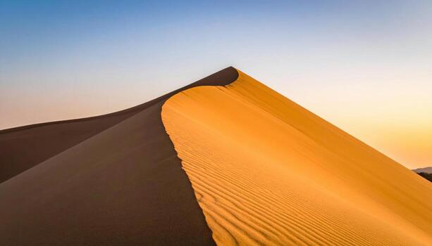 Close view of wind rippled dune slip face with untouched crest spacious gradient sky representing desert form suitable for calm natural design photo