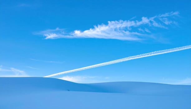 Faint contrail remnant dissolving into pale blue tranquil empty sky wallpaper background representing atmospheric sky texture suitable for clean minimal design photo