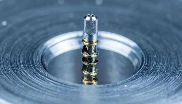 Helicoil insert partially installed in tapped aluminum clean studio macro representing thread repair hardware suitable for industrial product design photo