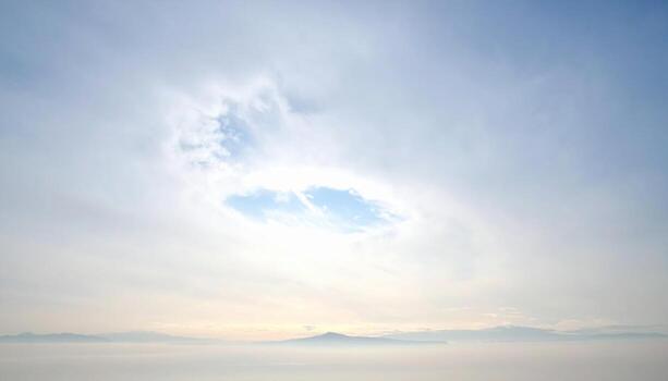 Uniform overcast with one brighter patch gentle center falloff uncluttered sky representing atmospheric backdrop suitable for calm editorial and branding design photo